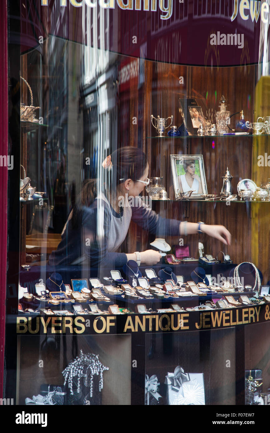 Female selecting an item of jewellery from a Jewellers window, England, UK Stock Photo