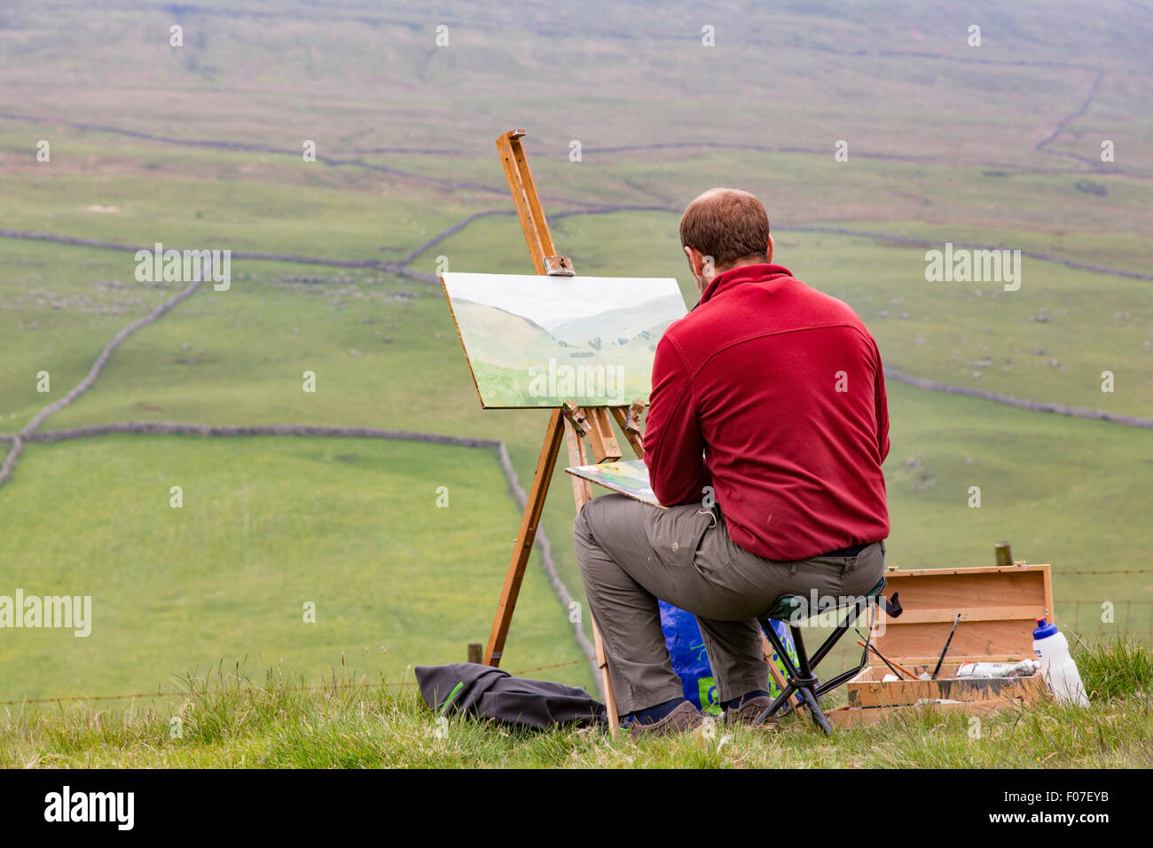 An artist painting the Yorkshire Dales landscape, North Yorkshire, England, UK Stock Photo