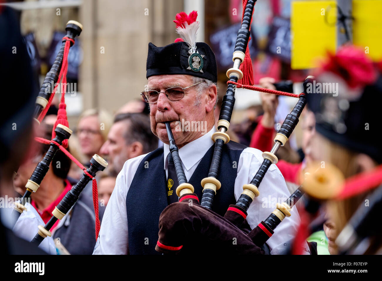 A piper playing at Pipefest 2015 - Massed Pipe Bands march down the Royal Mile in Edinburgh during the festival 2015 Stock Photo