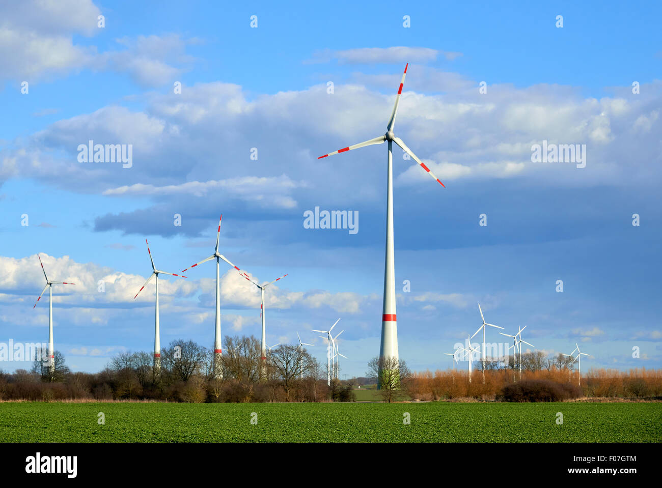 Wind turbines at the field. Eco energy industry Stock Photo - Alamy
