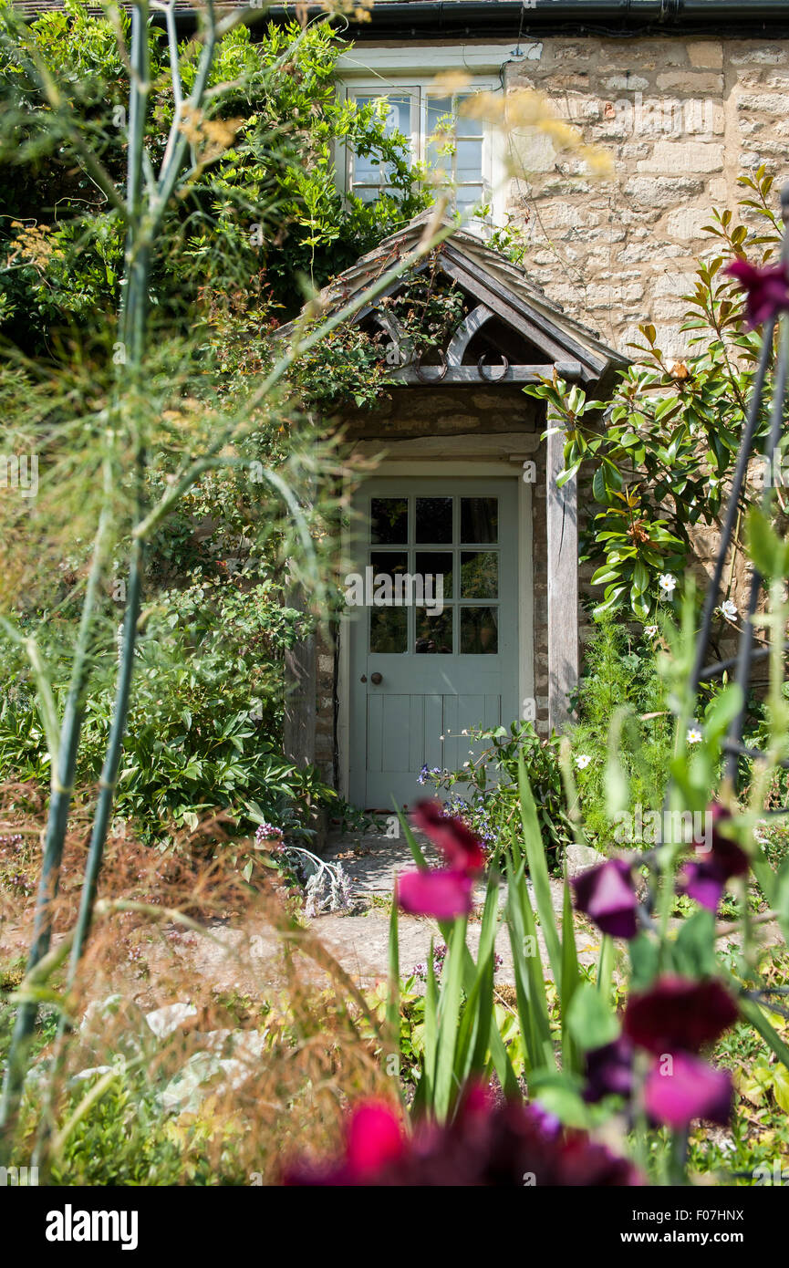 The Door Of A Quintessential English Country Cottage With Wild