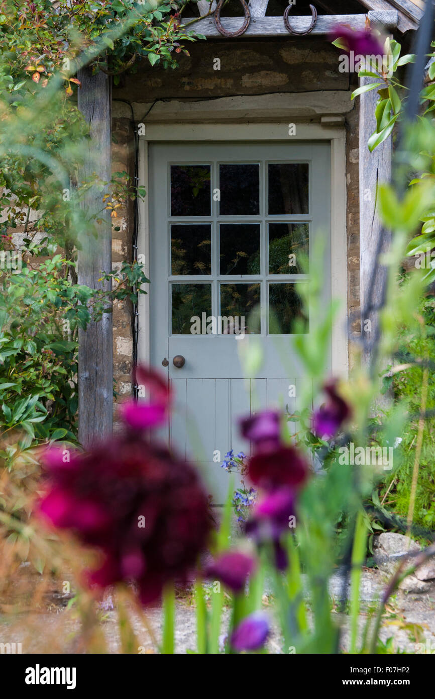 The Door Of A Quintessential English Country Cottage With Wild