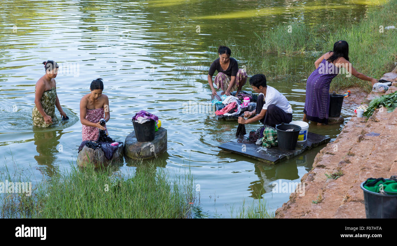 Women and a man wash laundry among the reeds in Botoloke Lake in Pindaya, Myanmar Stock Photo