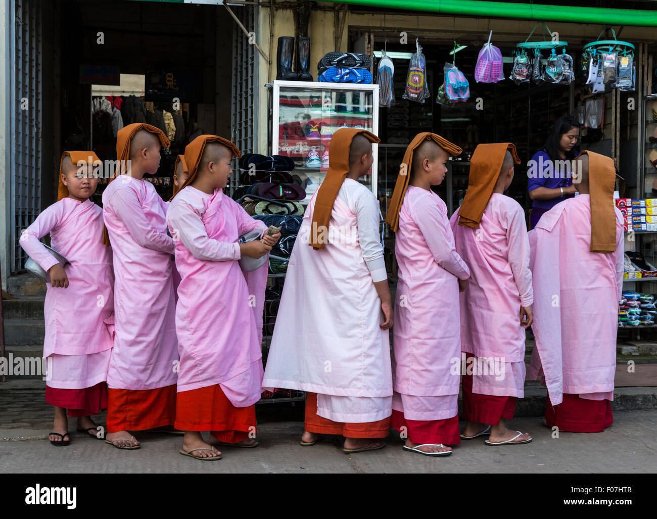 Buddhist nuns seek alms at the market in the historic Pyin Oo Lwin hill town near Mandalay in Myanmar Stock Photo