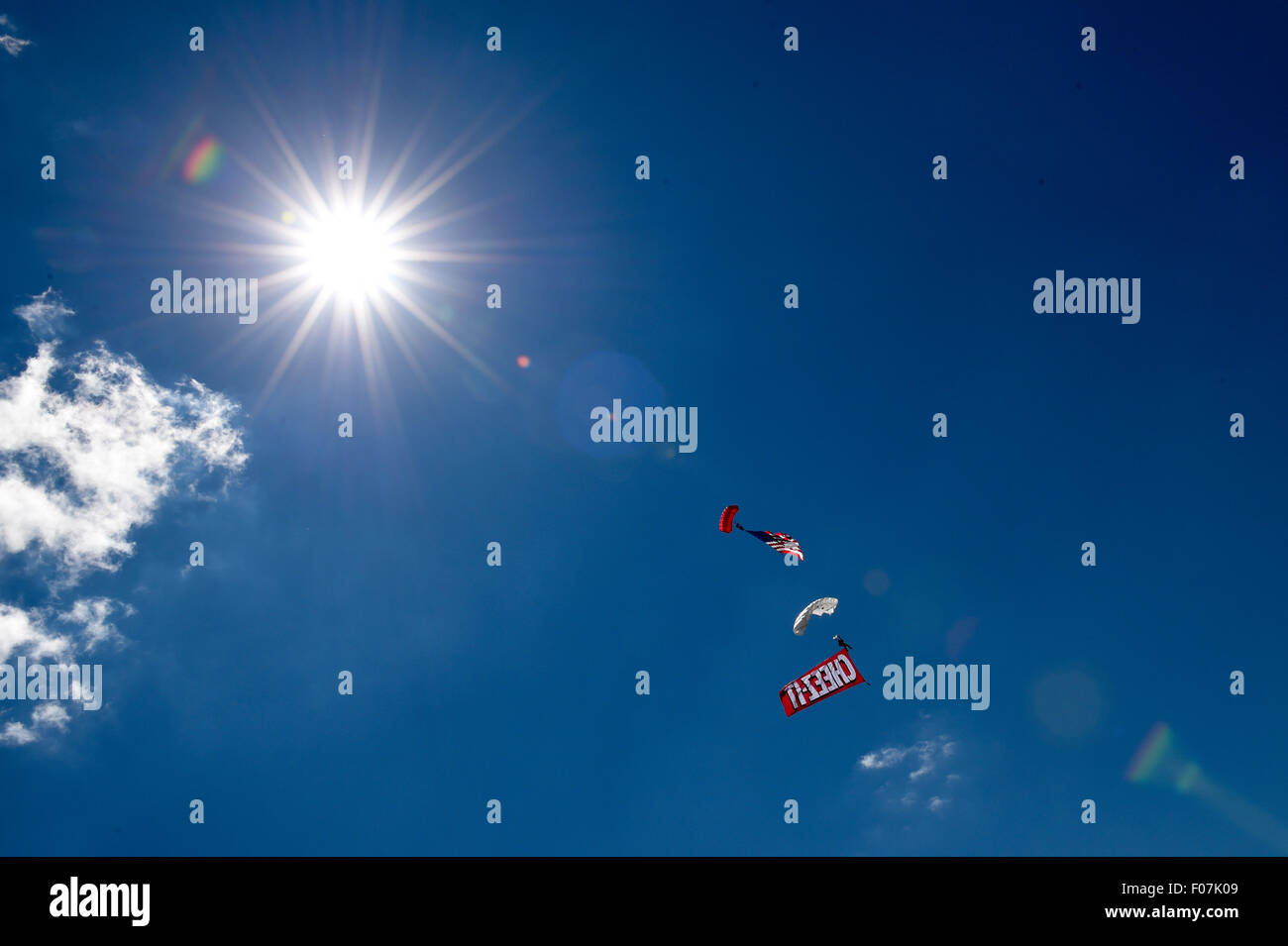 Watkins Glen, New York, USA. 9th Aug, 2015. Paratroopers descend on the track prior to the start of the NASCAR Sprint Cup Series Cheez-It 355 at The Glen at Watkins Glen International in Watkins Glen, New York. Rich Barnes/CSM/Alamy Live News Stock Photo