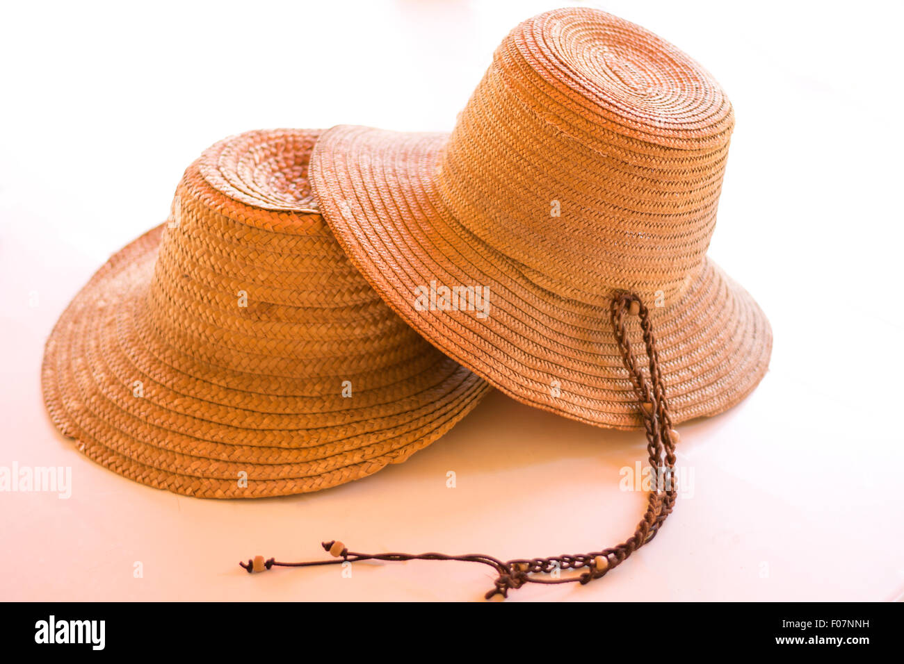 Two fashionable straw hats isolated on white. Stock Photo