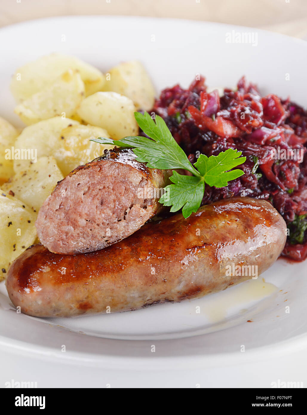 Bratwurst with Red Cabbage and Potatoes Stock Photo