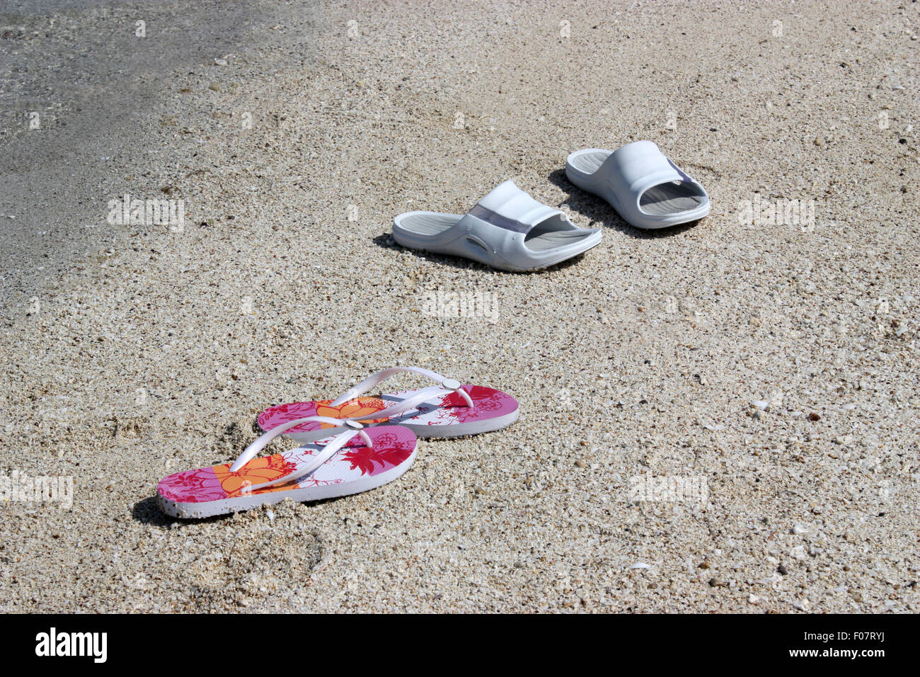 Sandals on the beach Stock Photo - Alamy