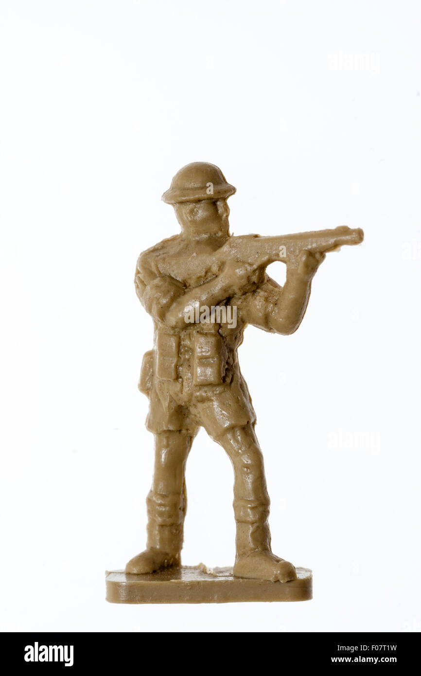 Airfix HO/OO plastic model toy soldier figure. World War Two 8th army soldier standing Thompson submachine gun against plain white background. Stock Photo