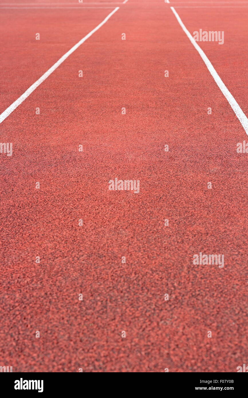 perspective of cinder running track at the sport stadium Stock Photo