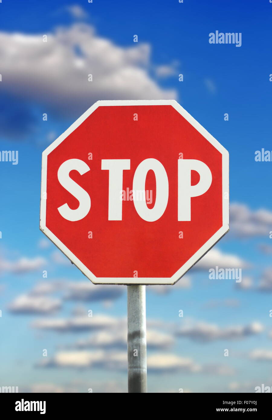 traffic sign - stop - over blue cloudy sky background Stock Photo