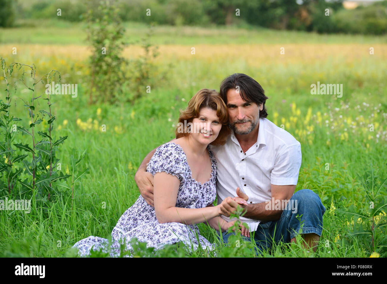 A Loving couple relaxing on a meadow Stock Photo