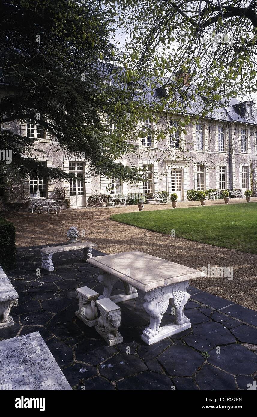 Stone table and bench in park of Chateau De Noirieux Hotel, Briollay, France Stock Photo