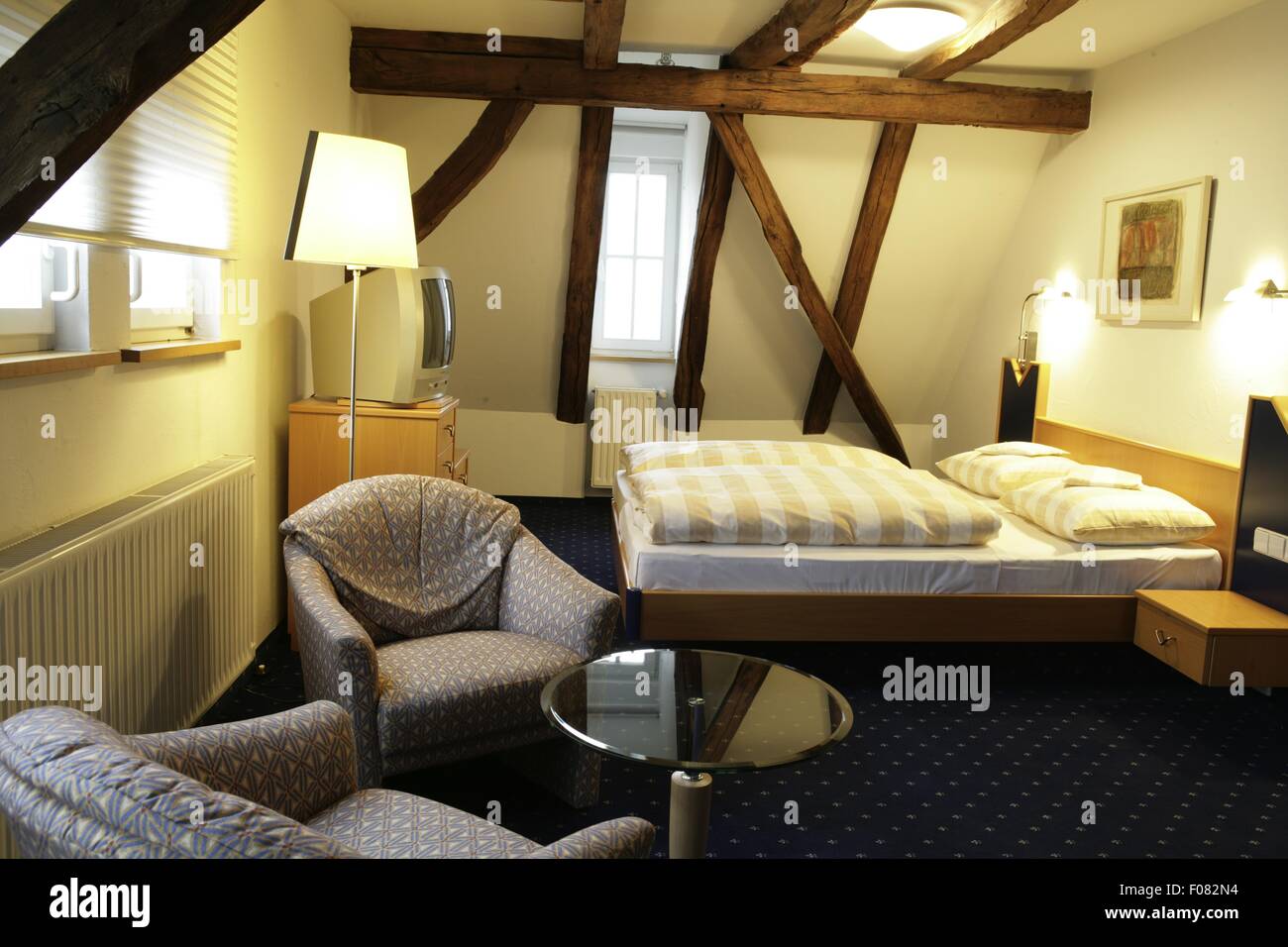 Bedroom of hotel with wooden ceiling, Germany Stock Photo Alamy