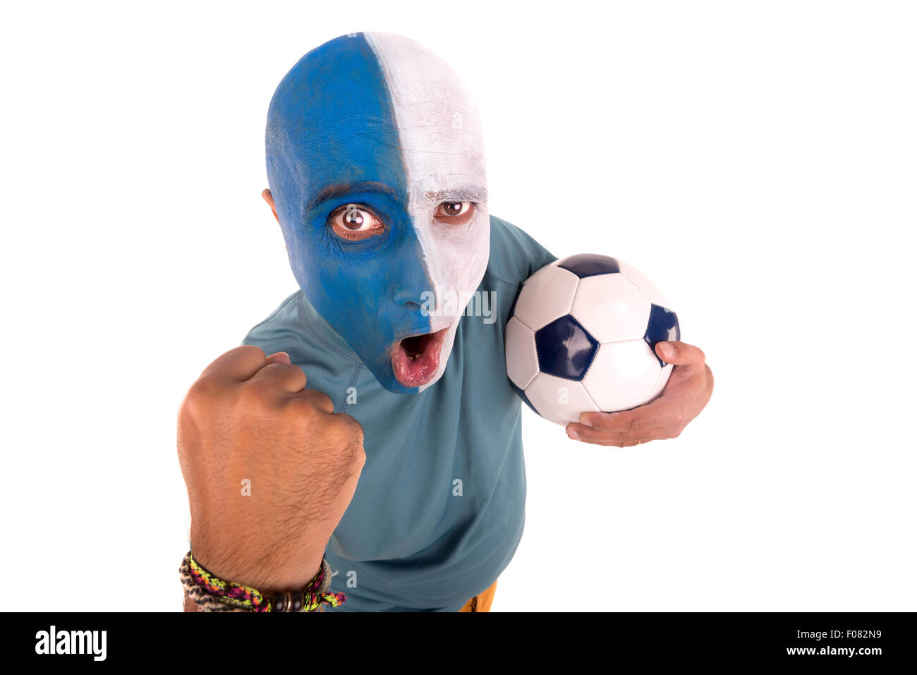 Football supporter with painted face with ball Stock Photo