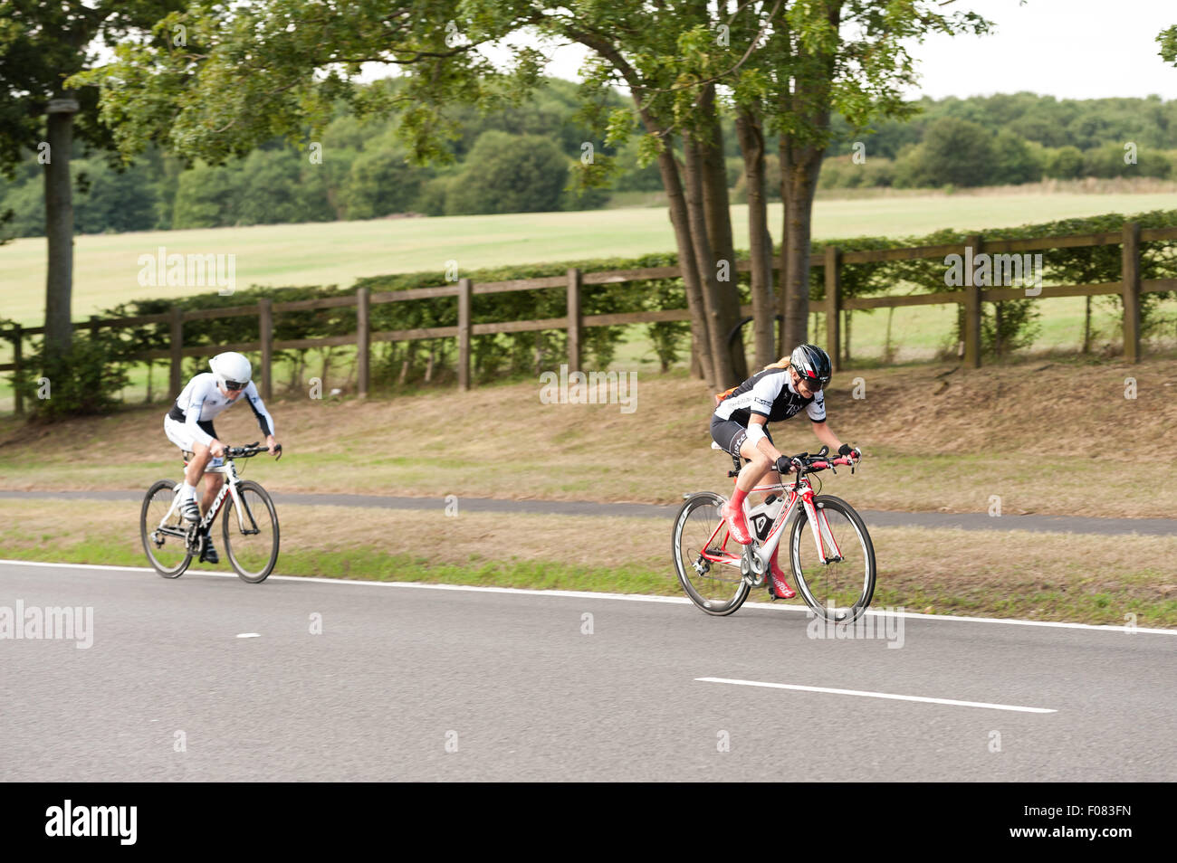 TT time trial cycling pairs on Brands Hatch road dedicated gear equipment bikes and streamlined on very fast road summer evening Stock Photo