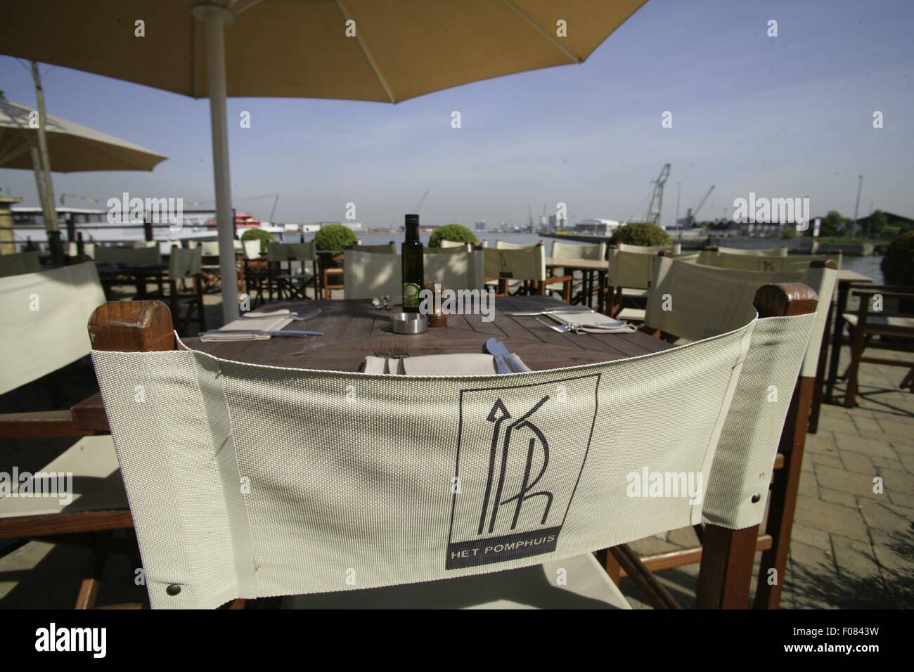 Restaurant signboard on chair against laid table, Belgium Stock Photo ...