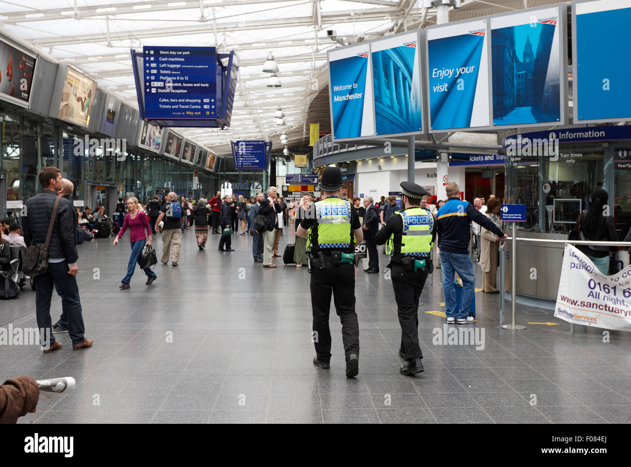 british transport police patrolling Manchester piccadilly railway station England UK Stock Photo