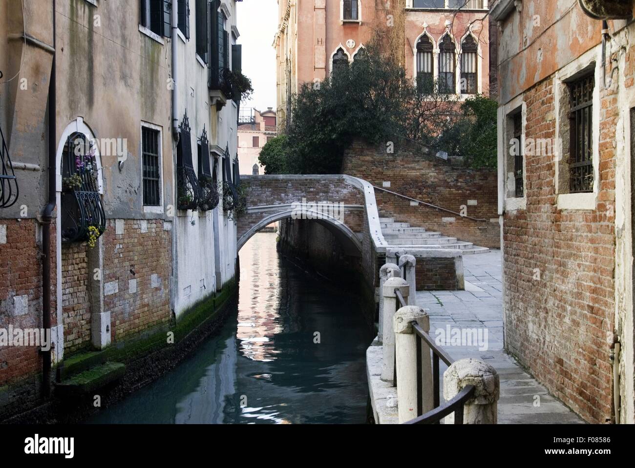 Canal Railing View of narrow canal, railing, houses and bridge in Campiello Barbaro ...