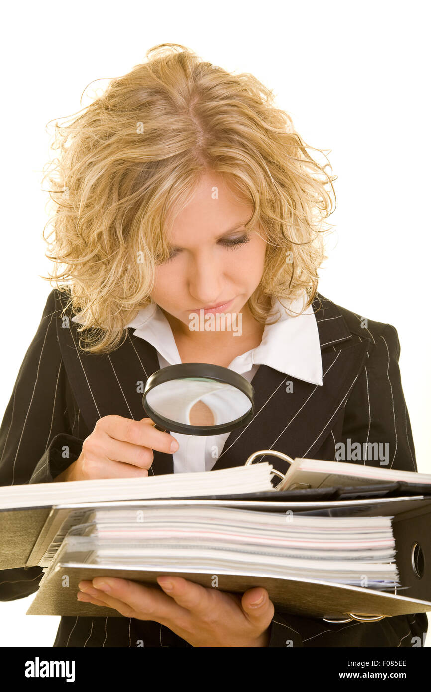 Business woman checking a contract with magnifying glass Stock Photo