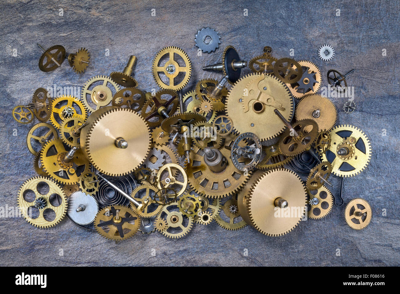 Selection of dusty old brass clock parts. Stock Photo