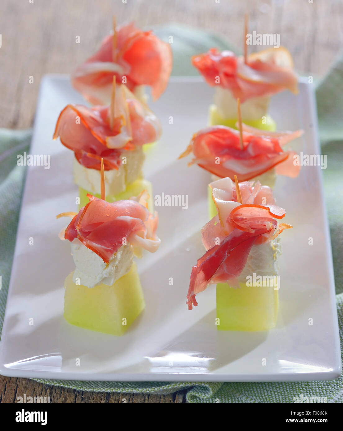 Ham, cheese and melon on plate Stock Photo
