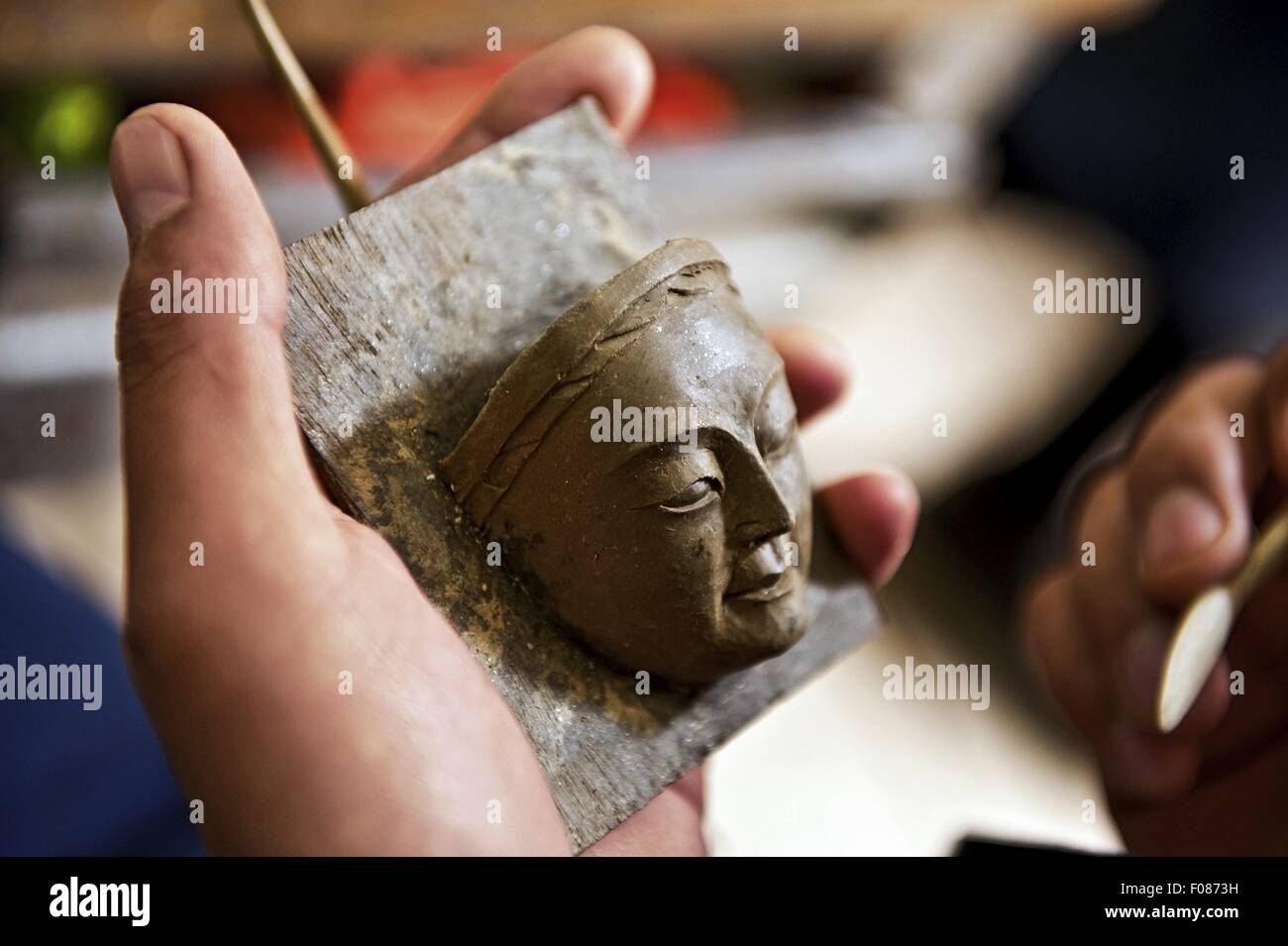 Close-up of hand's modelling mask of Buddha in School of Art, Bhutan Stock Photo
