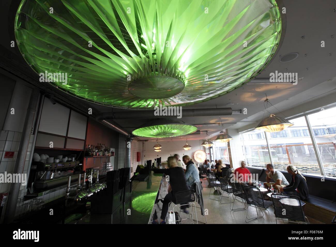 People at Karriere Bar with green lamps on ceiling, Copenhagen, Denmark Stock Photo