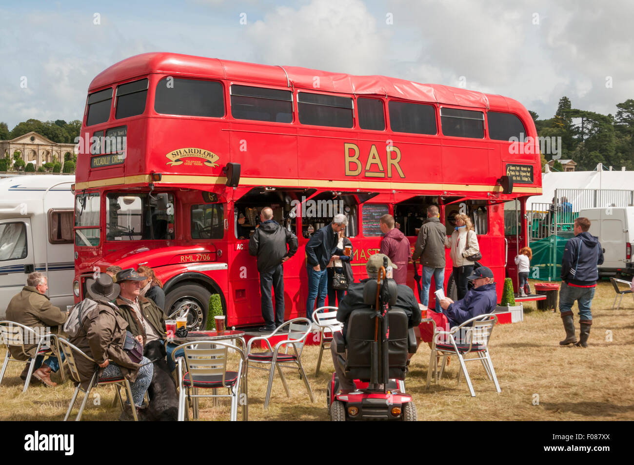 A red London double-decker Routemaster bus converted for use as a bar, at the Holkham Country Fair. Stock Photo