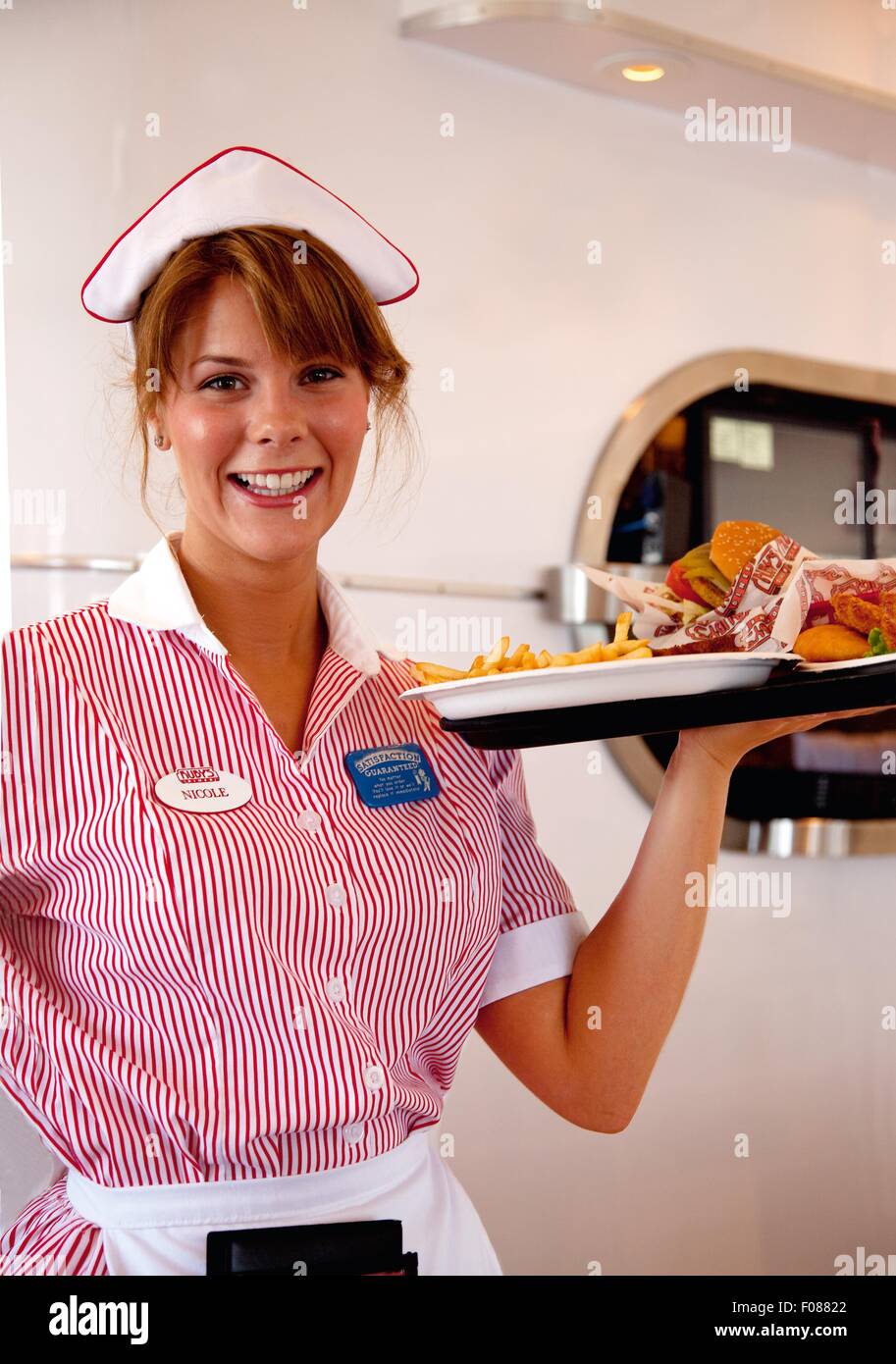 Waiter at Ruby's Diner wearing striped uniform holding serving tray Stock  Photo - Alamy