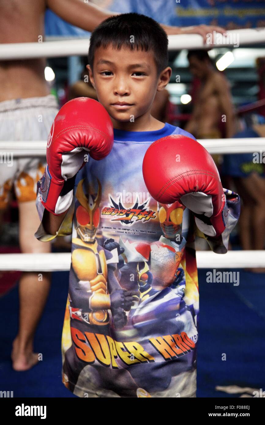 Portrait of boy wearing printed tshirt and boxing gloves, Bangkok