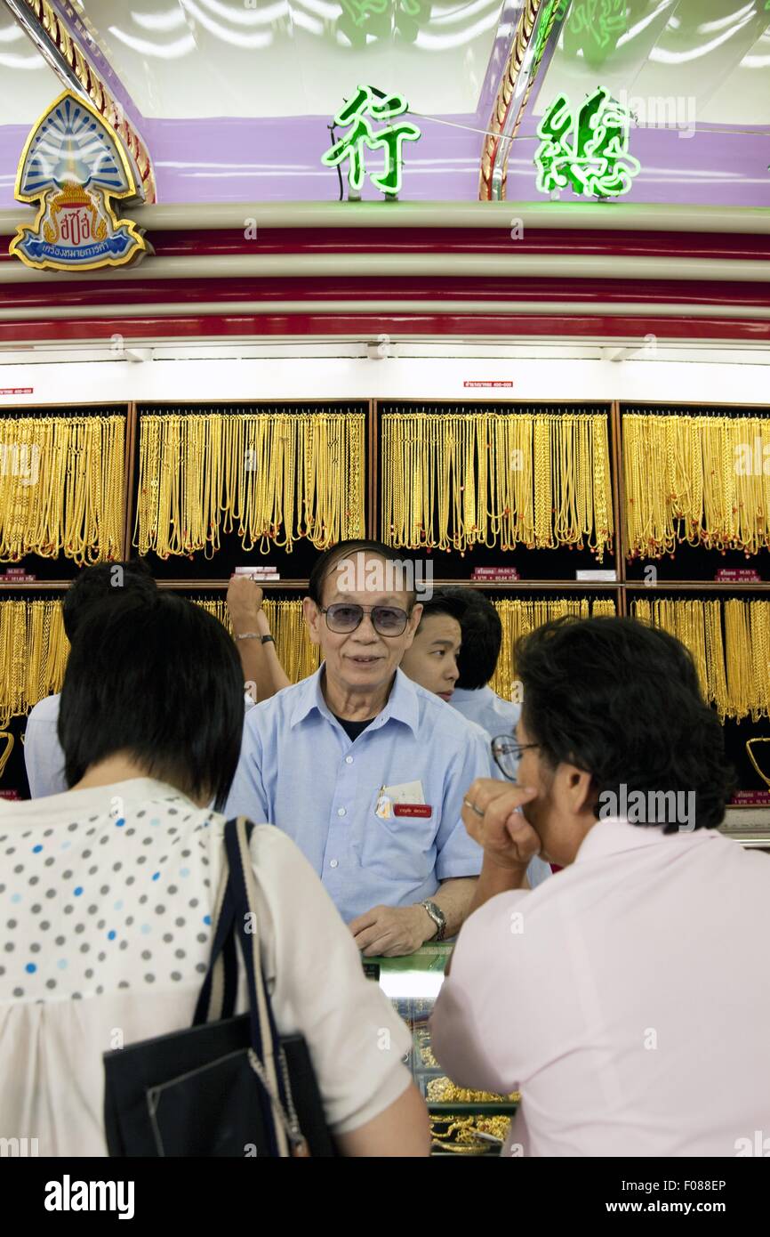 Dealers displaying jewellery to customers in jewellery shop, Thailand Stock Photo