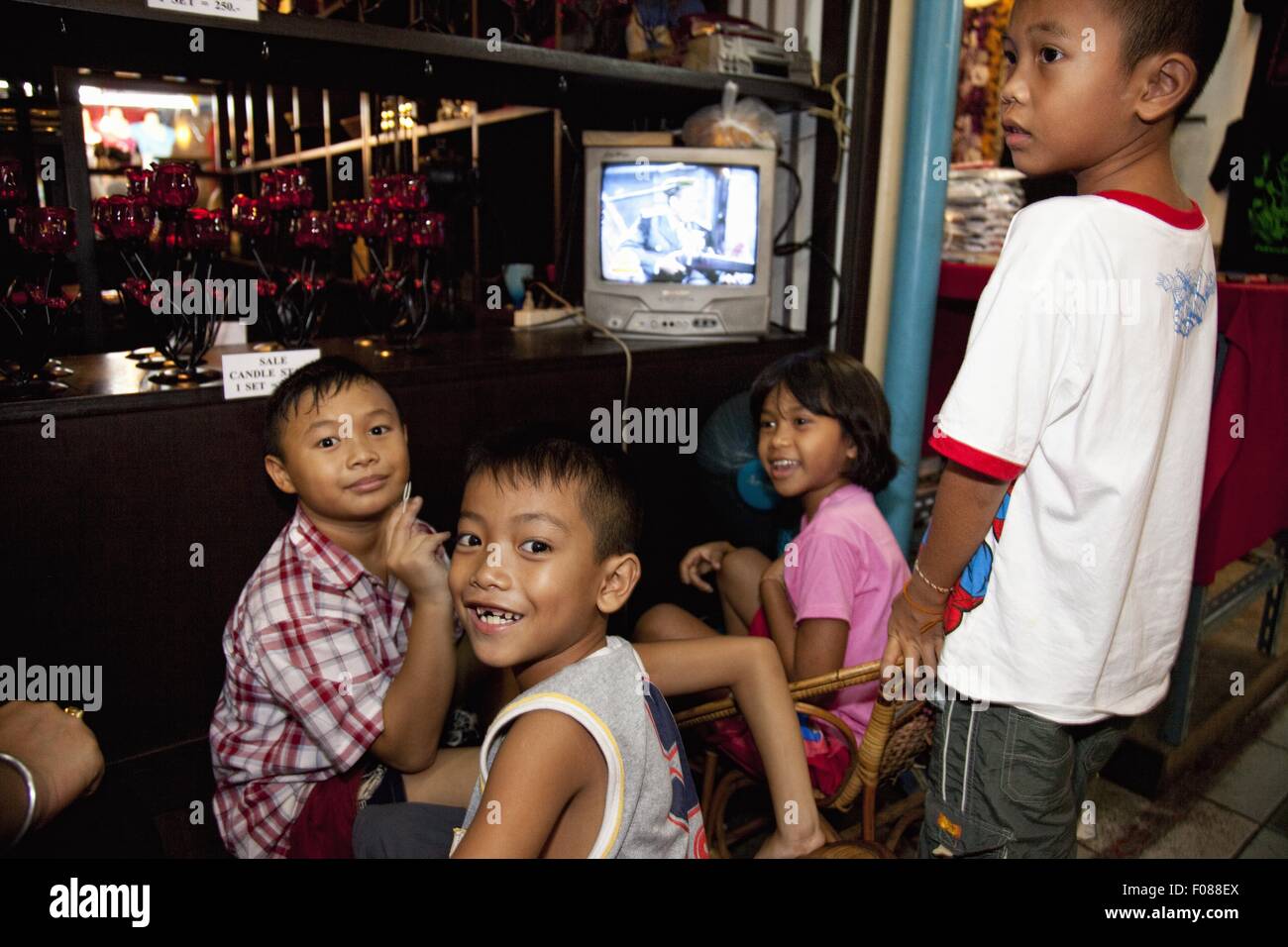 Happy children watching TV at home, Thailand Stock Photo