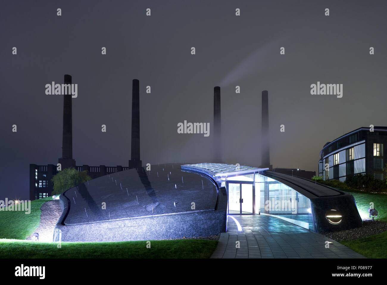 Entrance of Premium Club House at night, Autostadt Wolfsburg, Germany