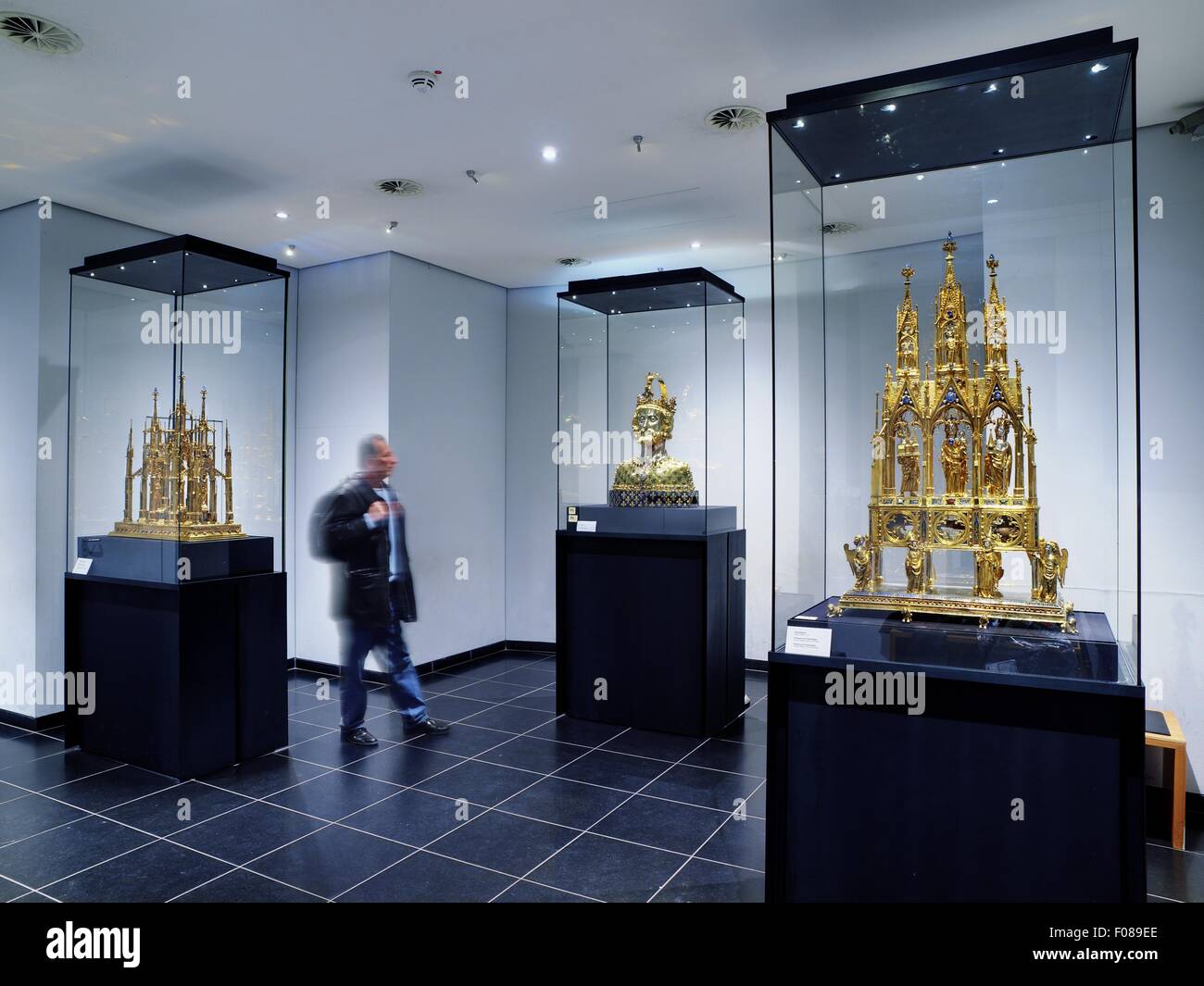 Man looking at exhibits in glass boxes at the Cathedral Treasury, Germany, blurred motion Stock Photo