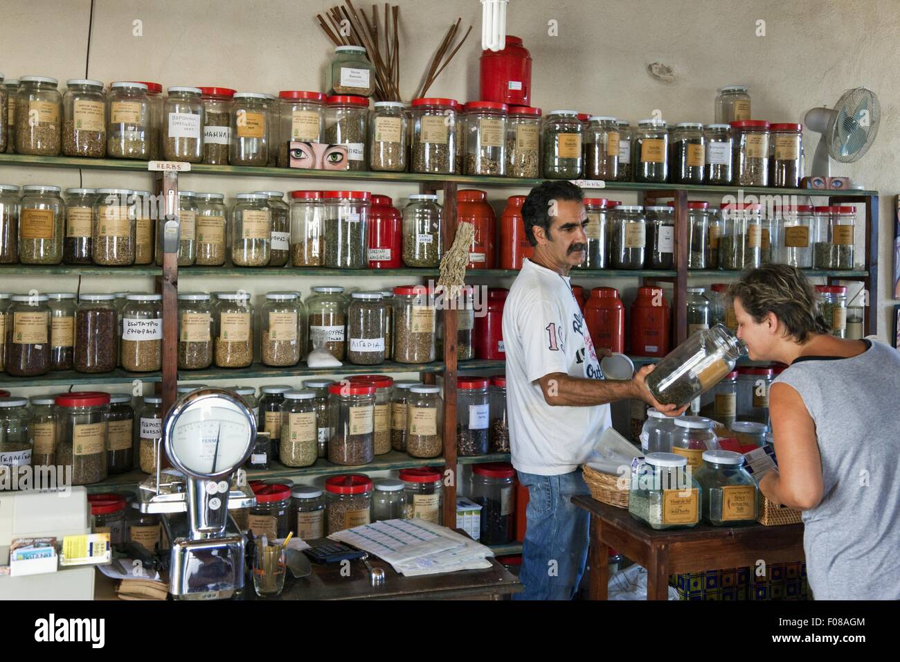 Herb Shop dealer Yannis Giannoutsos attending customer, Crete, Greece Stock  Photo - Alamy