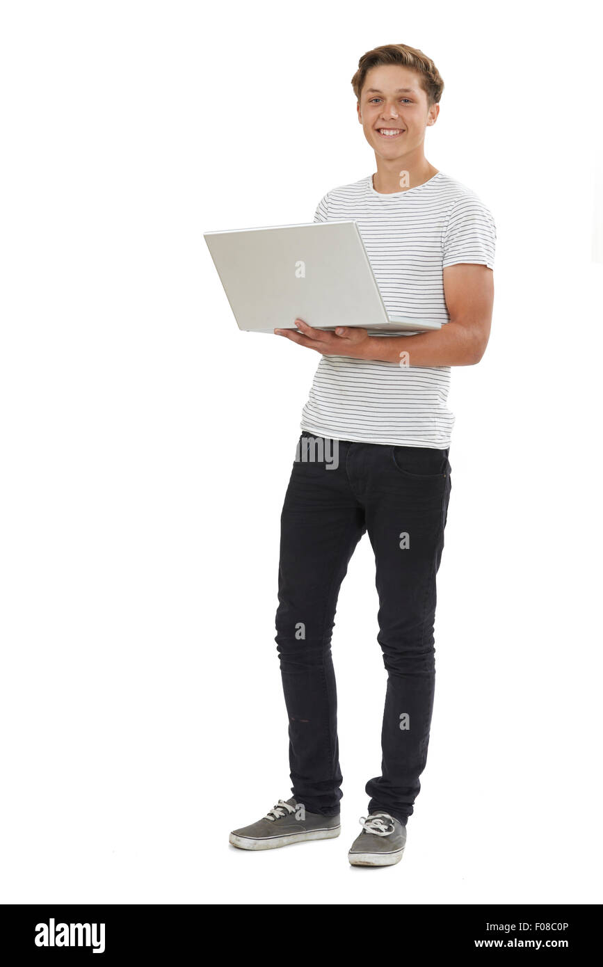 Full Length Studio Shot Of Teenage Boy Using Laptop Stock Photo