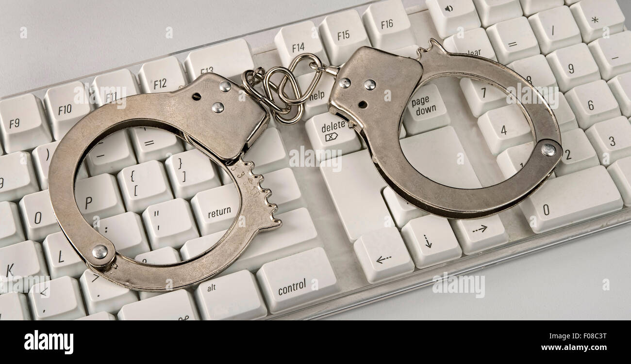 Computer security with criminal handcuffs on it. Stock Photo