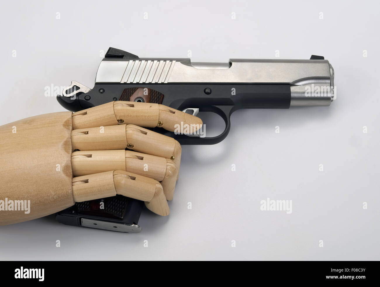 45 Caliber handgun with wooden arm. Stock Photo