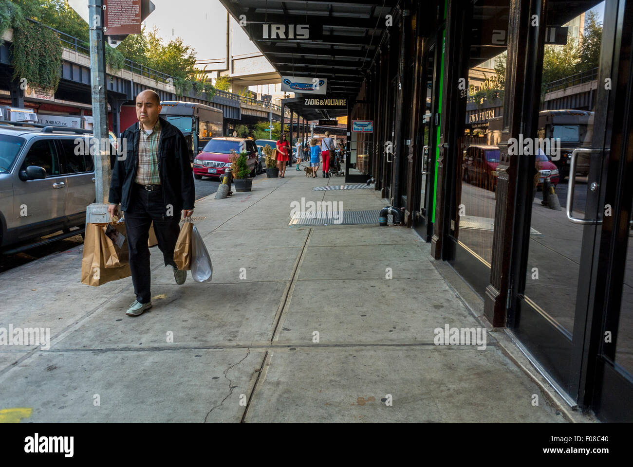 New York City, USA, Street Scenes, Meat Packing District, Man Carrying Shopping Bags, Clothing Fashion, urban walking, garment shops exterior Stock Photo