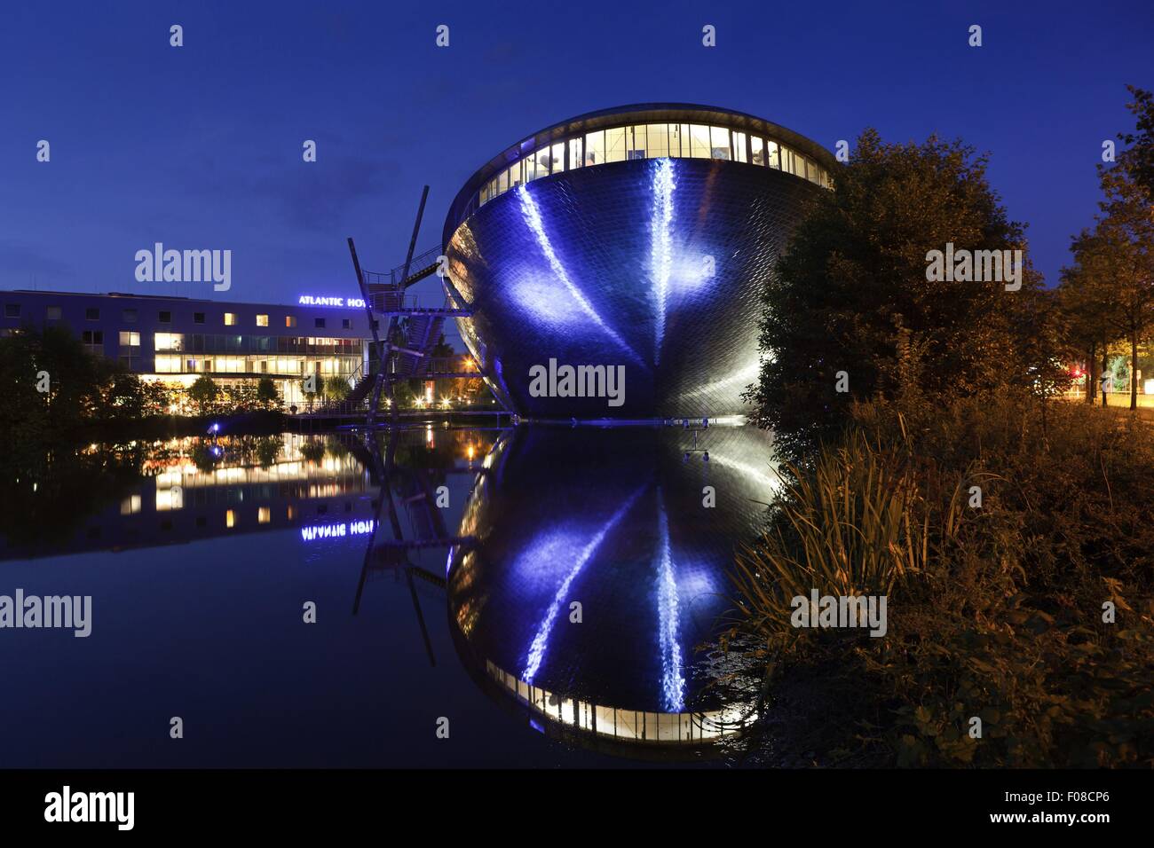 Symmetrical reflection of Atlantic Hotel Universum at night, Bremen, Germany Stock Photo
