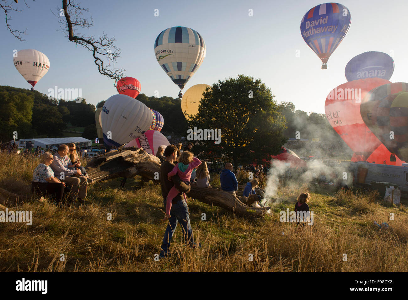 Families watch the mass lift-off by balloons at Bristols annual fiesta at Ashton Court, UK. Stock Photo