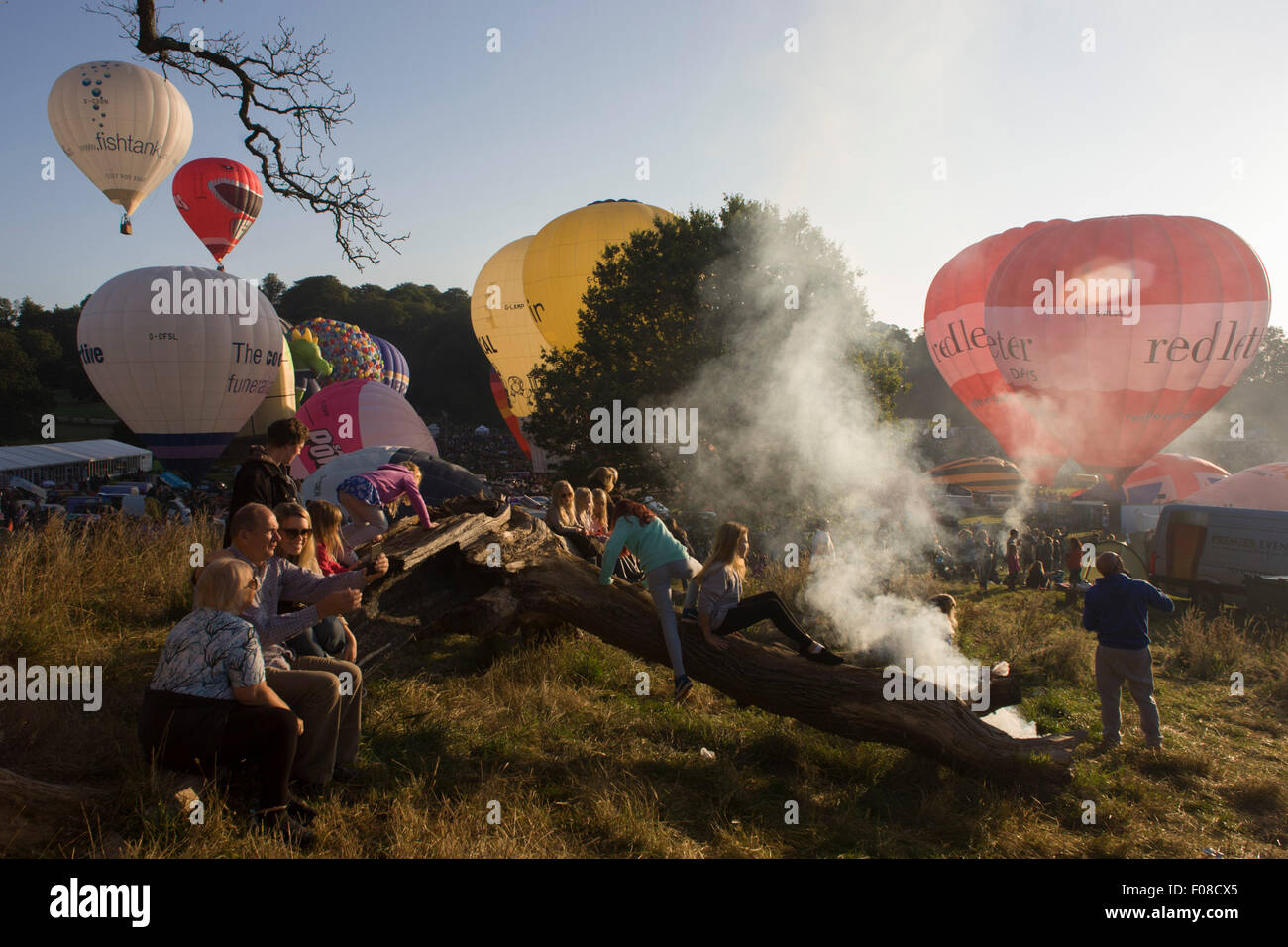 Families watch the mass lift-off by balloons at Bristols annual fiesta at Ashton Court, UK. Stock Photo