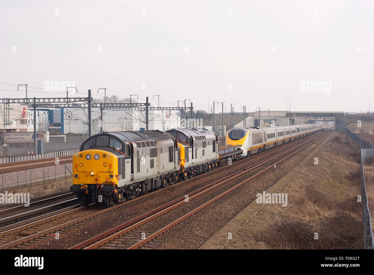 A Pair of Class 37 diesel locomotives numbers 37604 and 37603 with Eurostar set numbers 3311 and 3312 at Sevington in Kent. 17th March 2006. Stock Photo