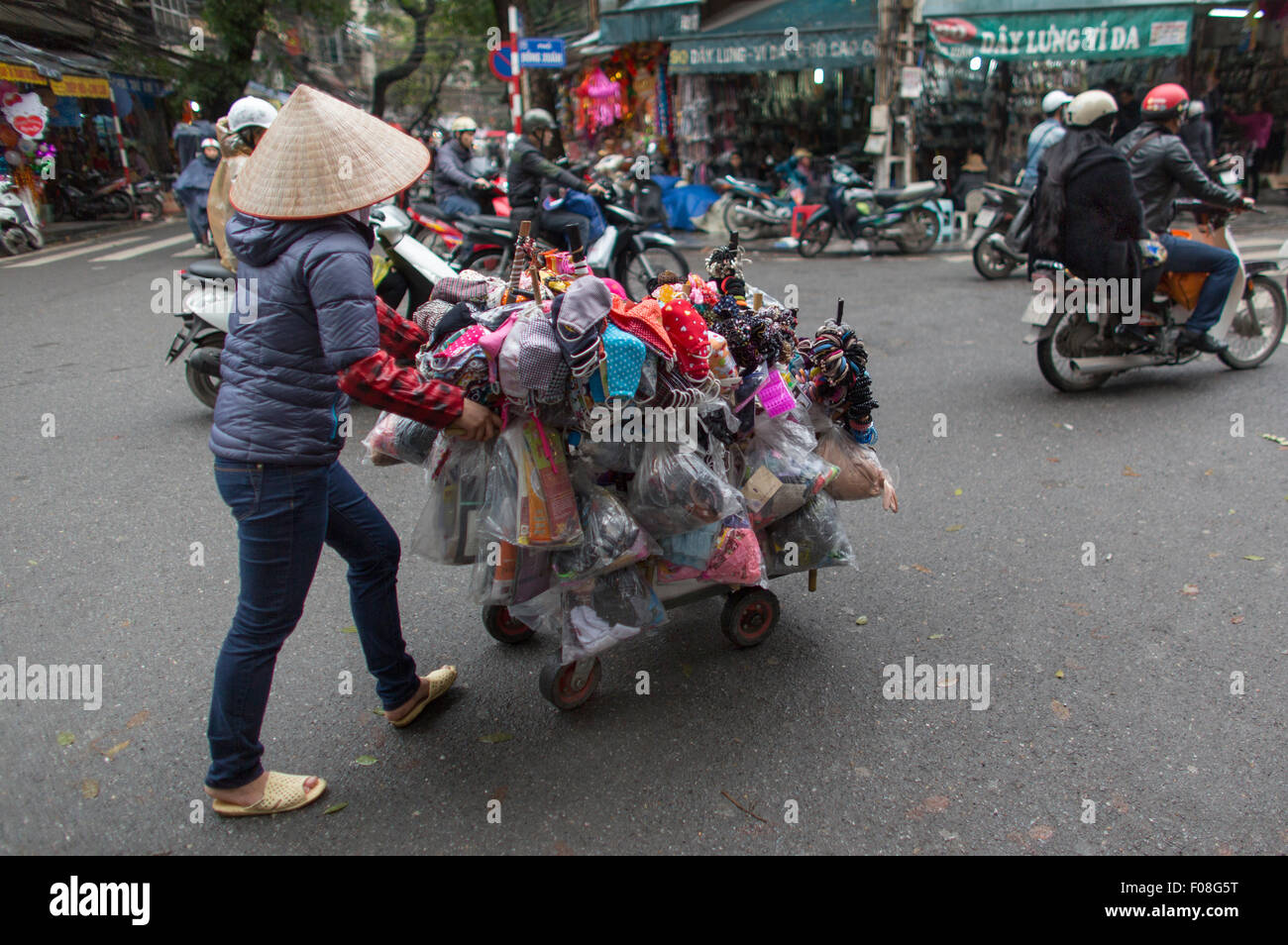 vendor selling products from her mobile bicycle shop Stock Photo