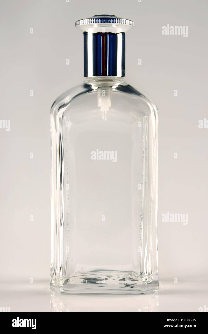 An empty transparent perfume bottle isolated on white background. Stock Photo