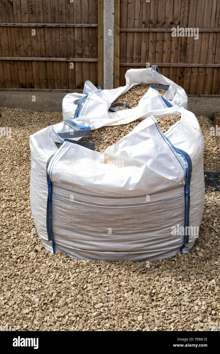 Large 1 ton bags of gravel (Cotswold Buff) in a garden Stock Photo - Alamy