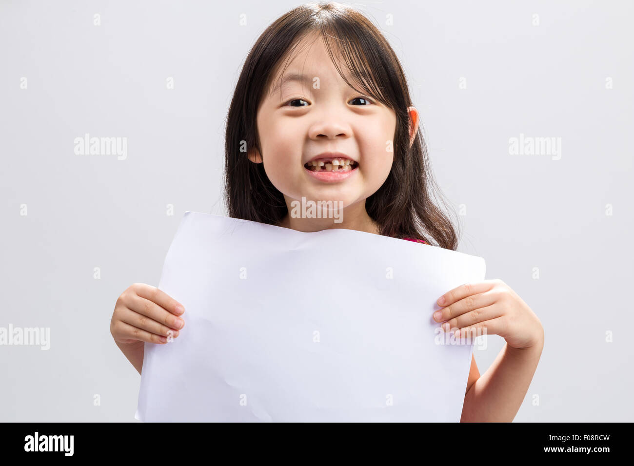 Studio isolated kid holding white sheet of blank paper Stock Photo Alamy