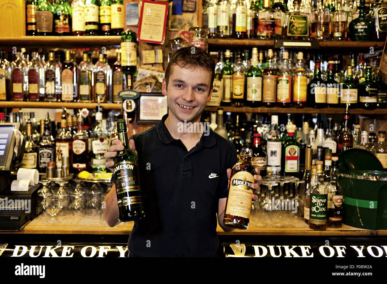 Bartender showing collection of wines in Pub Duke of York, Belfast, Ireland Stock Photo