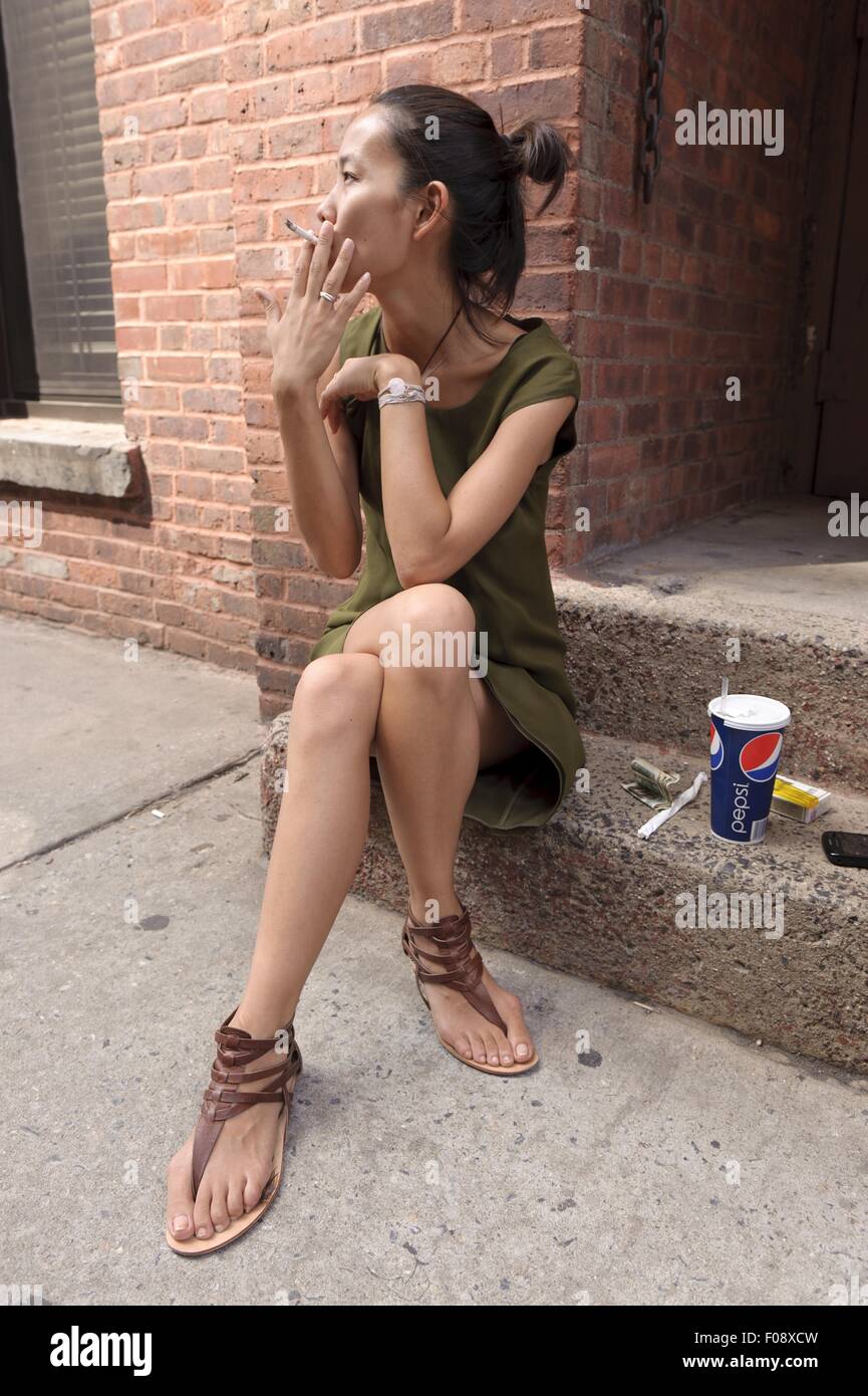 Woman sitting on steps and smoking in New York, USA Stock Photo Alamy